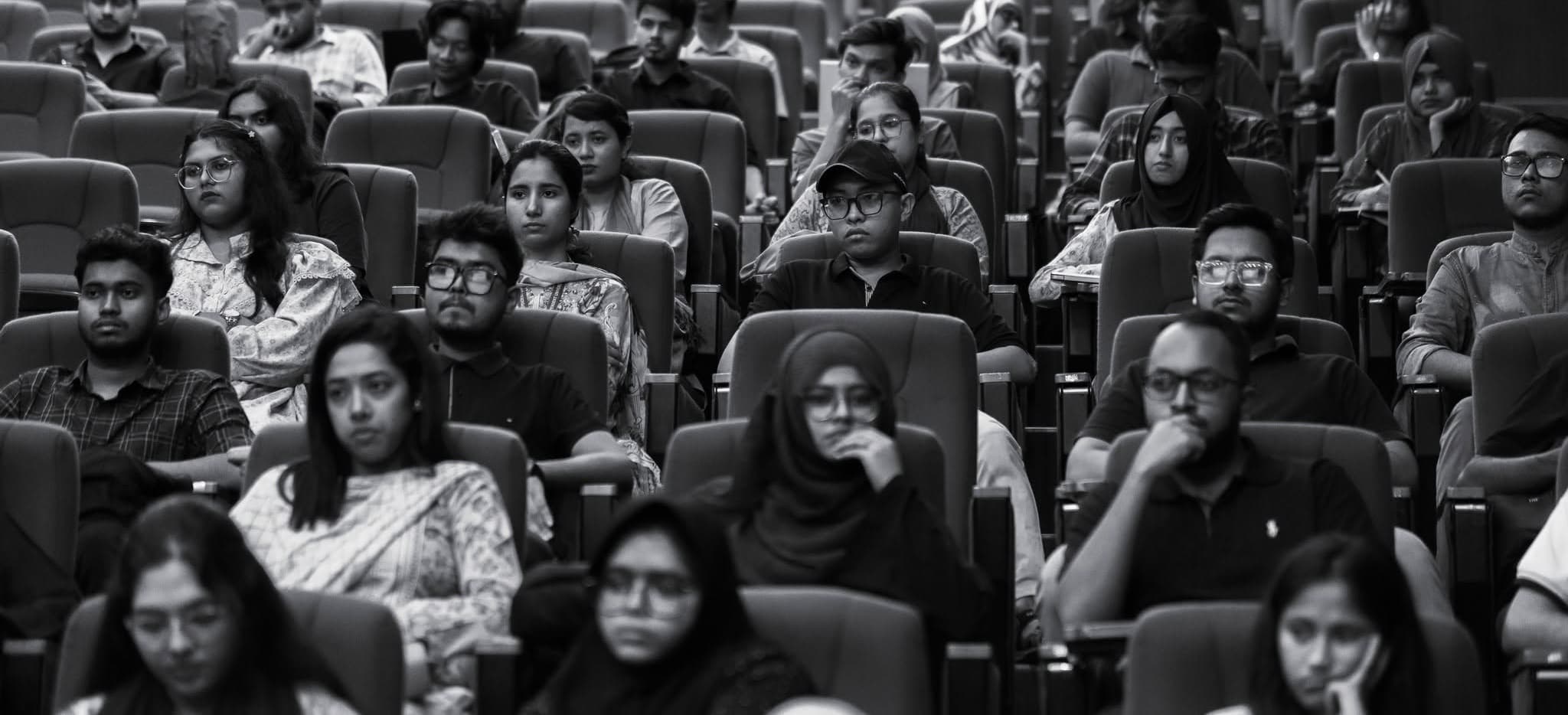 Black and white photo of an audience of students listening at an AppLink session